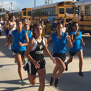 Female students running in a cross country meet