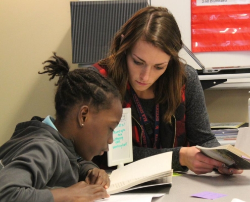 teacher and student reading together