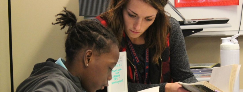 teacher and student reading together