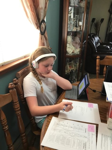 Student learning from home from her tablet